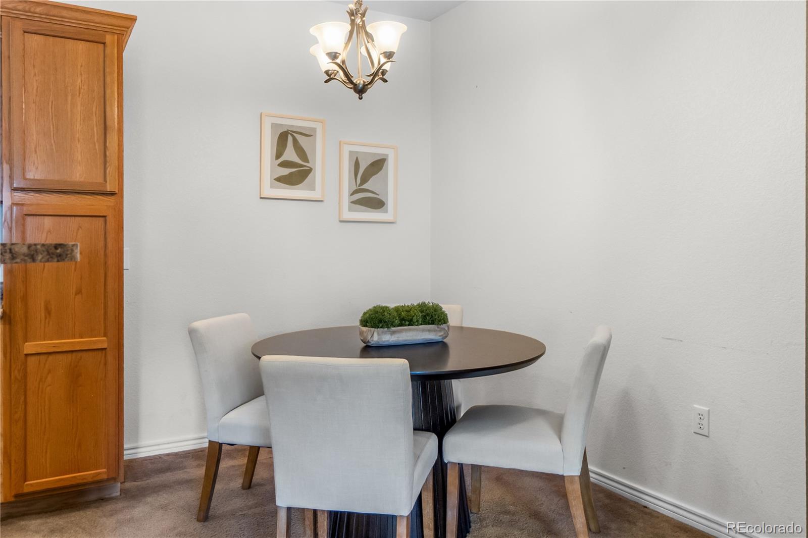 18669 Stroh Road, Unit 10204 Parker, CO 80134 - Photo 6 of 24 a view of a dining room with furniture and wooden floor
