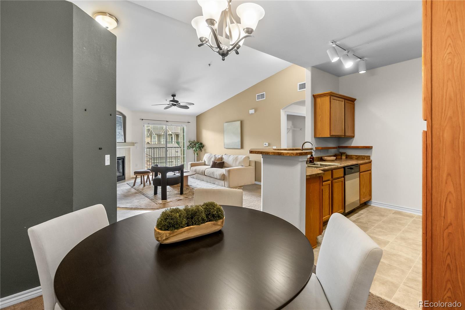 18669 Stroh Road, Unit 10204 Parker, CO 80134 - Photo 7 of 24 a living room with kitchen island furniture and a chandelier