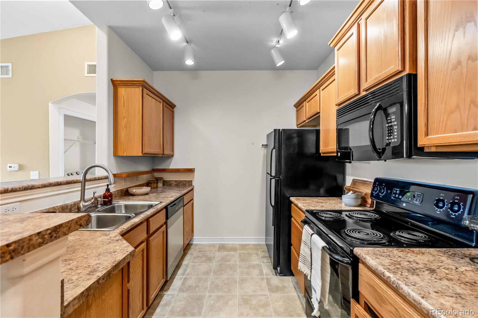 18669 Stroh Road, Unit 10204 Parker, CO 80134 - Photo 8 of 24 a kitchen with stainless steel appliances granite countertop a sink stove and refrigerator