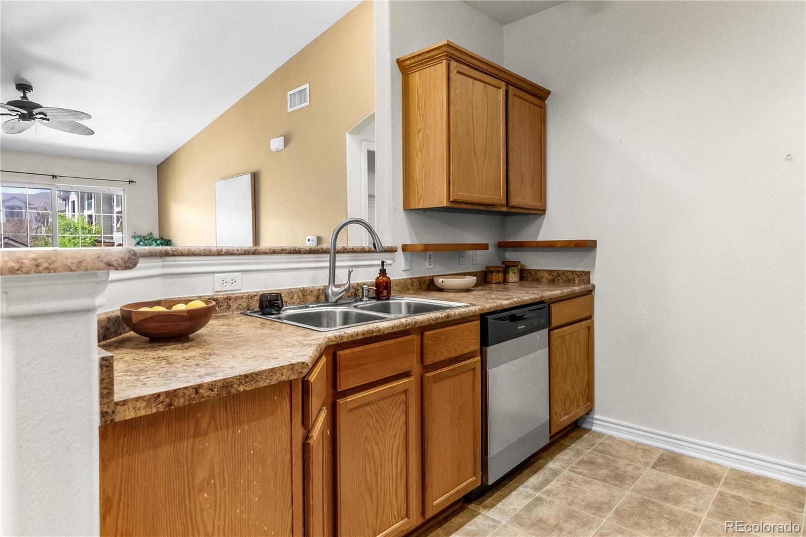 18669 Stroh Road, Unit 10204 Parker, CO 80134 - Photo 10 of 24 a kitchen with sink cabinets and a wooden floor