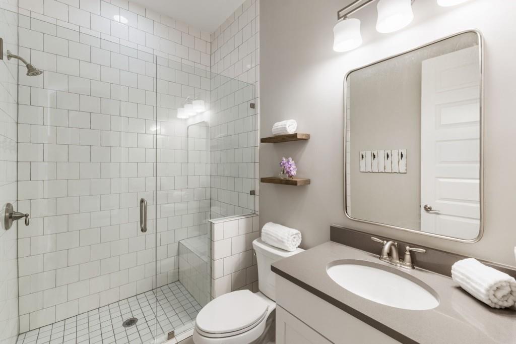 1105 Lee Street Milton, GA 30004 - Photo 23 of 47 a bathroom with a sink a toilet and shower