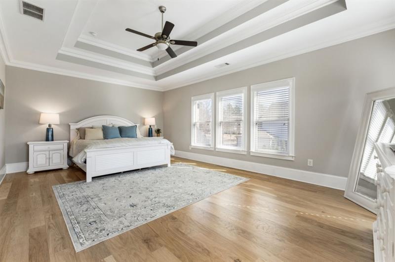 1105 Lee Street Milton, GA 30004 - Photo 25 of 47 a bedroom with a large bed a chandelier and a window
