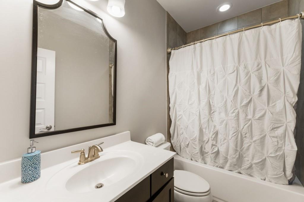 1105 Lee Street Milton, GA 30004 - Photo 31 of 47 a bathroom with a sink toilet and shower