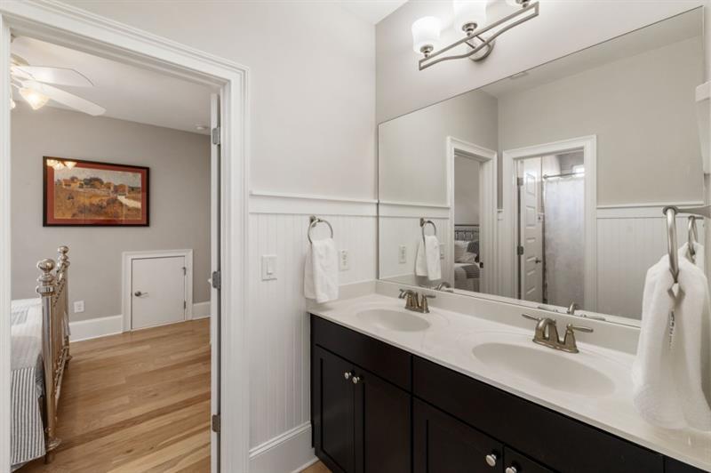1105 Lee Street Milton, GA 30004 - Photo 33 of 47 a bathroom with a double vanity sink a mirror and a shower