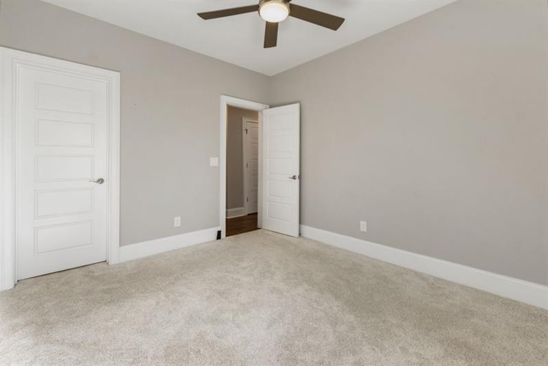 1105 Lee Street Milton, GA 30004 - Photo 42 of 47 an empty room with a ceiling fan and a window
