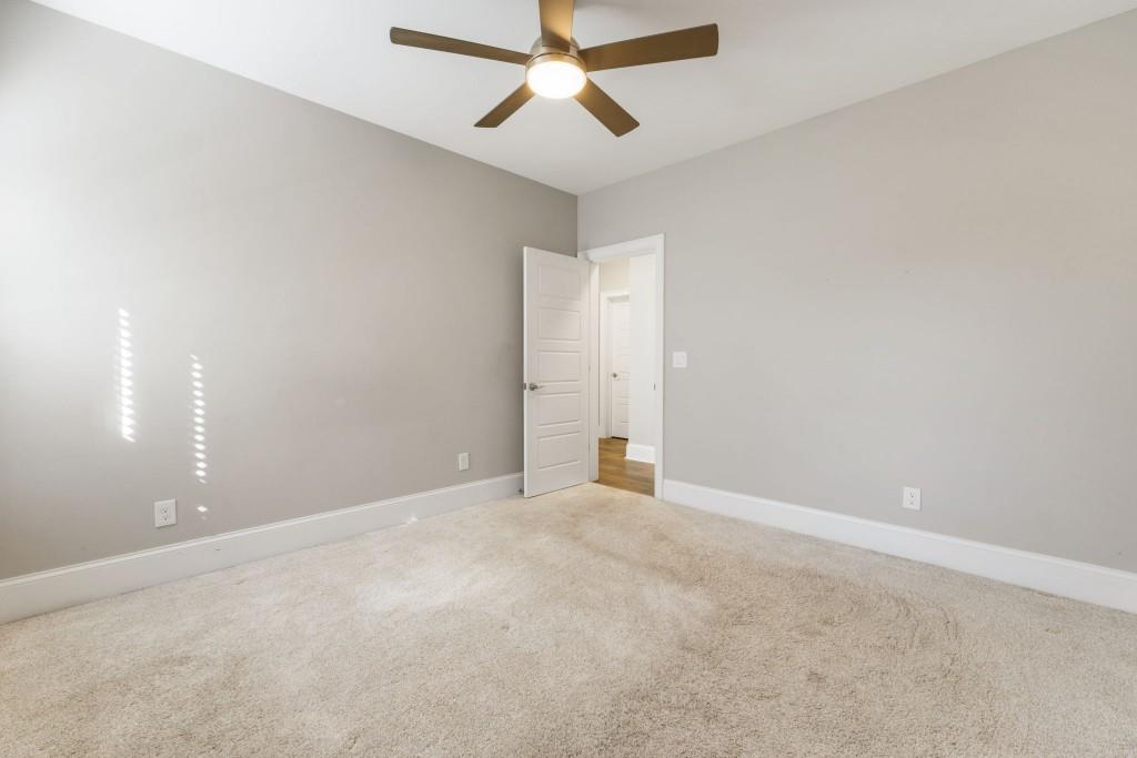 1105 Lee Street Milton, GA 30004 - Photo 43 of 47 an empty room with chandelier fan and windows