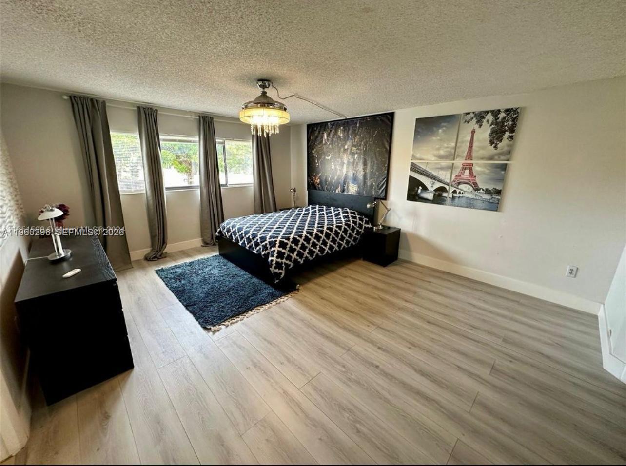 10640 Southwest 75th Lane Miami, FL 33173 - Photo 15 of 21 a bedroom with a bed mirror and window