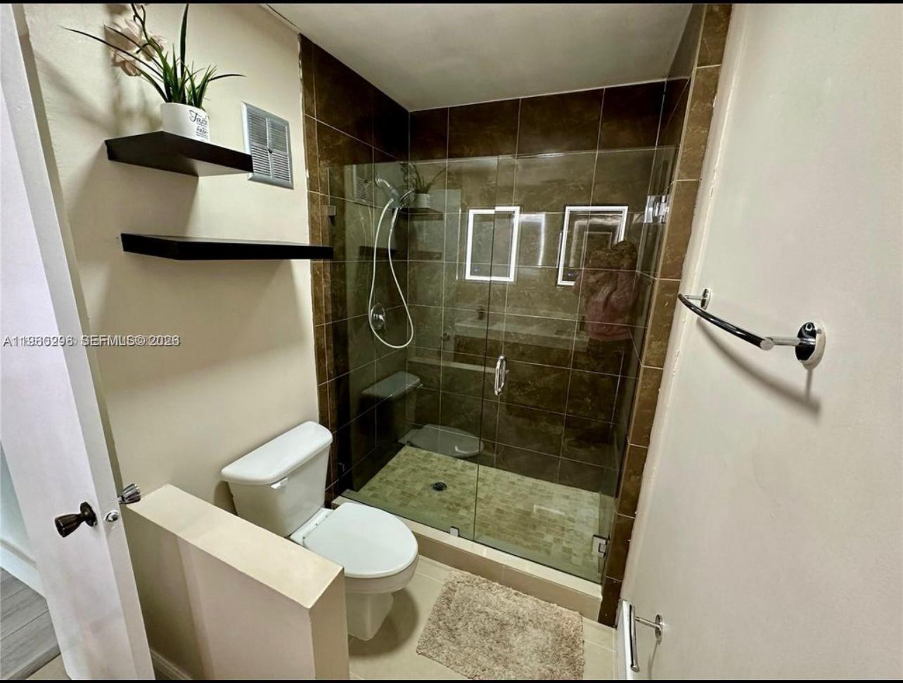 10640 Southwest 75th Lane Miami, FL 33173 - Photo 17 of 21 a bathroom with a shower and toilet
