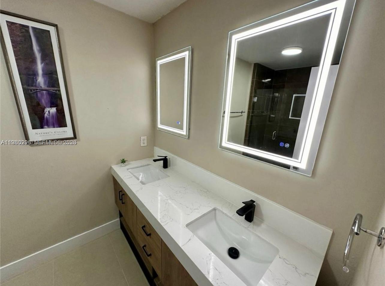 10640 Southwest 75th Lane Miami, FL 33173 - Photo 18 of 21 a bathroom with a sink and a mirror