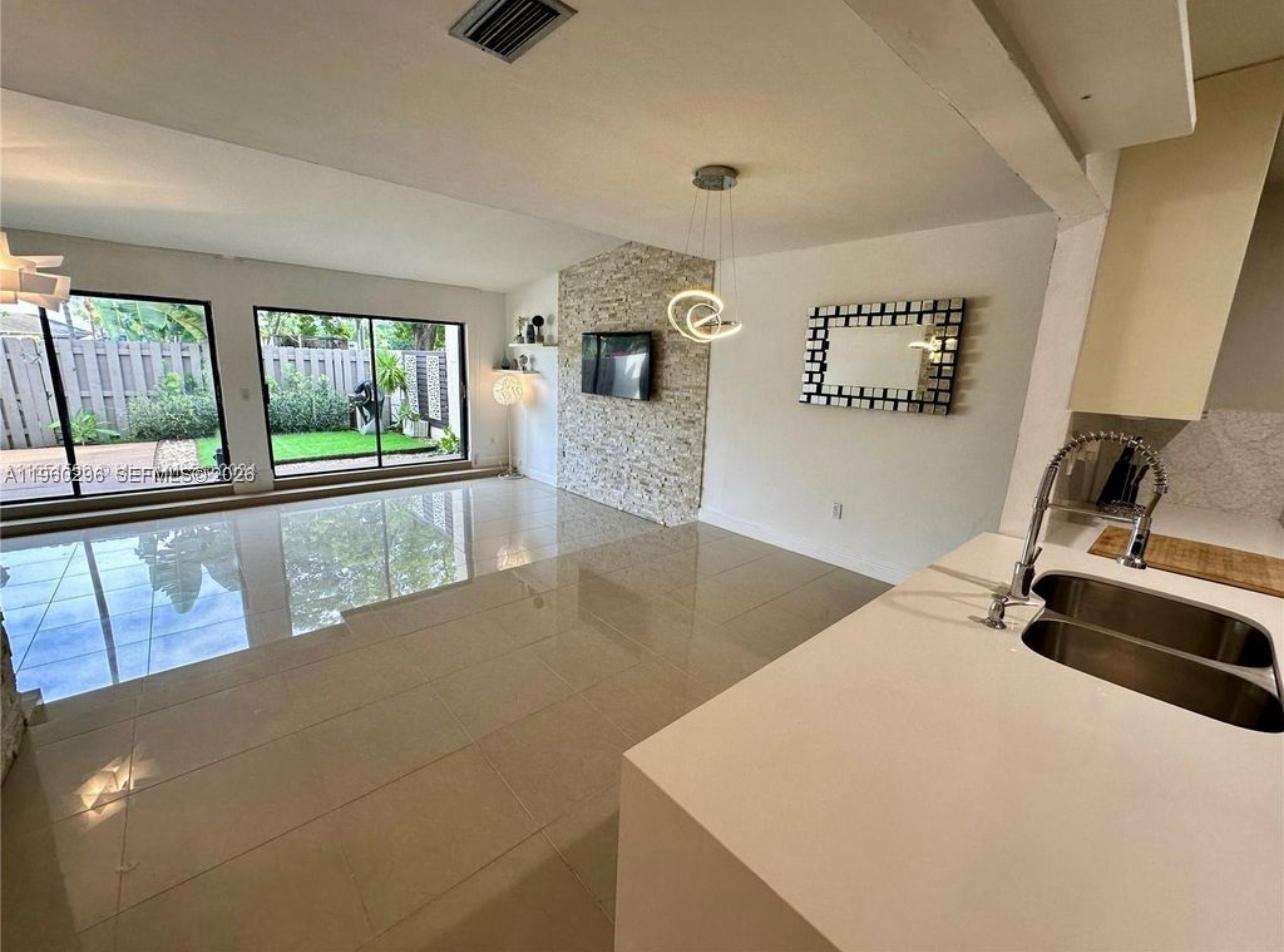 10640 Southwest 75th Lane Miami, FL 33173 - Photo 5 of 21 a view of a hallway to a livingroom with furniture