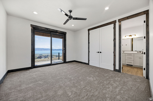 300 Knoll Loop, Unit 227 Fish Haven, ID 83287 - Photo 13 of 56 Unfurnished bedroom featuring a water and mountain view, access to outside, light carpet, ceiling fan, and recessed lighting