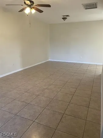 an empty room with a ceiling fan