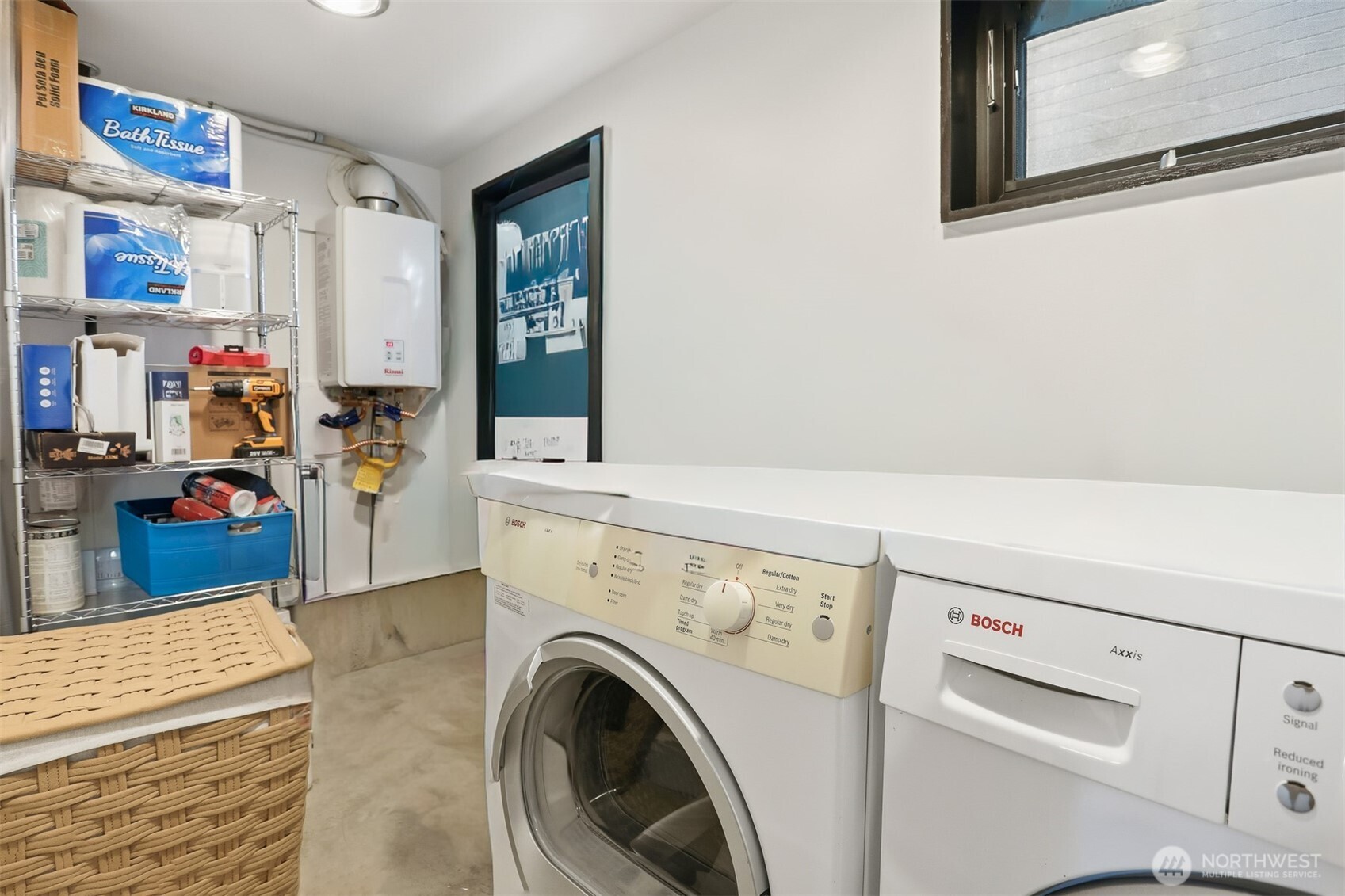 3868 16th Avenue Southwest Seattle, WA 98106 - Photo 11 of 37 a view of washer and dryer with kitchen in the background