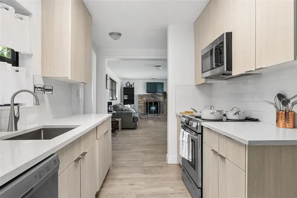 a kitchen with a sink stove and cabinets