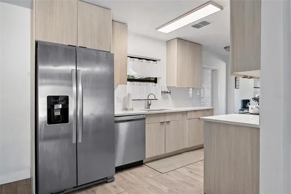 a kitchen with a refrigerator and a sink