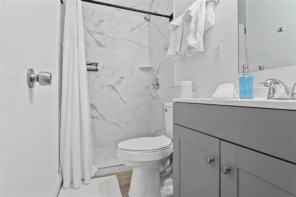 a bathroom with a toilet sink and shower