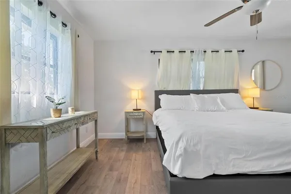 a bedroom with a bed and wooden floor