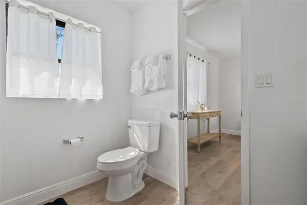 a bathroom with a toilet a sink and a shower