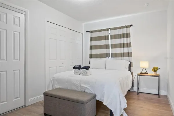 a bedroom with a bed and a window