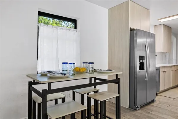 a view of a kitchen with a table and chairs