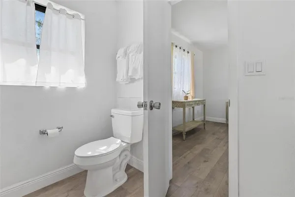 a white toilet sitting next to a bathroom sink