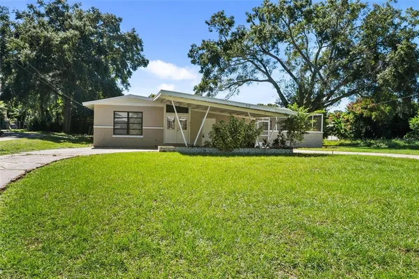 a front view of house with yard and green space