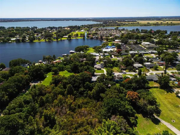 an aerial view of a city with lots of residential buildings lake and ocean view