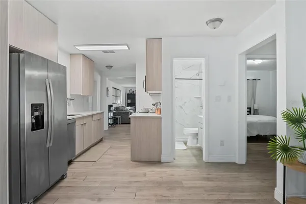 a kitchen with a refrigerator and a stove