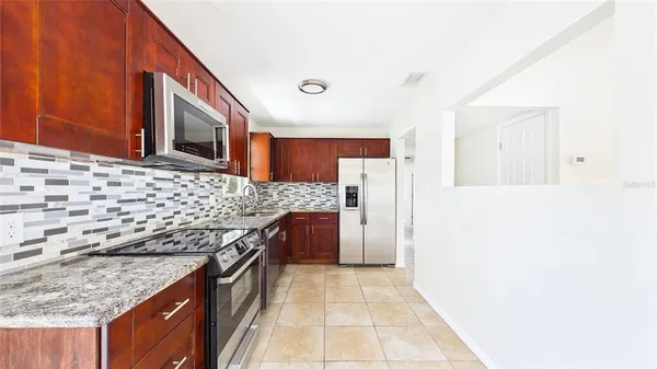 a open kitchen with a sink and a large window