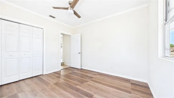 a utility room with water heater and racks