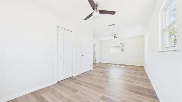 a view of empty room with wooden floor