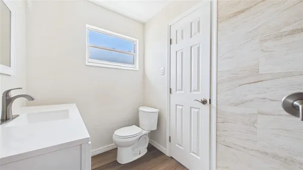 a view of a room with wooden floor