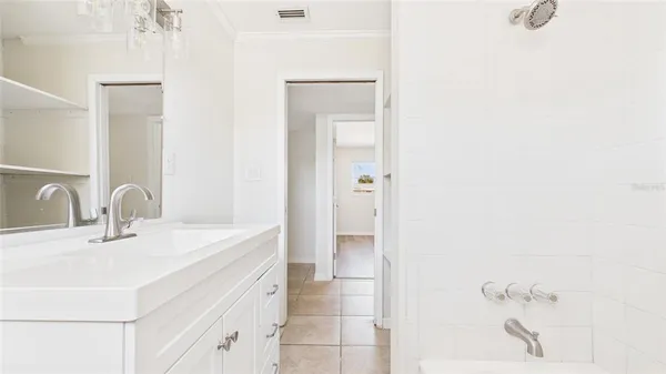 an empty room with a window and wooden floor