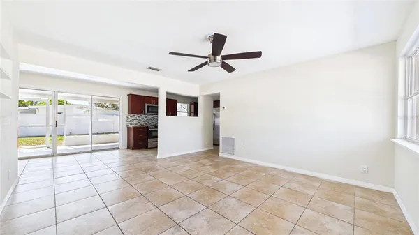 a view of a livingroom with a ceiling fan and window