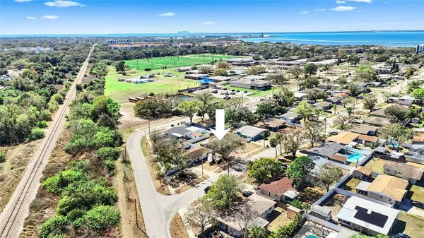 an aerial view of residential houses with city view