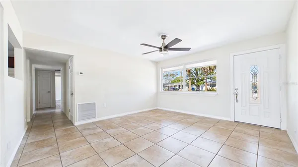a view of a kitchen with refrigerator and a sink