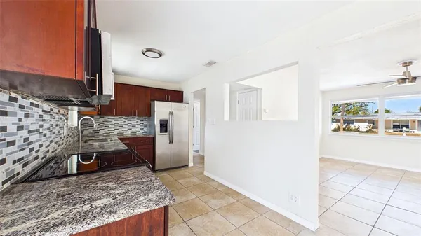 a kitchen with stainless steel appliances granite countertop a refrigerator stove and sink