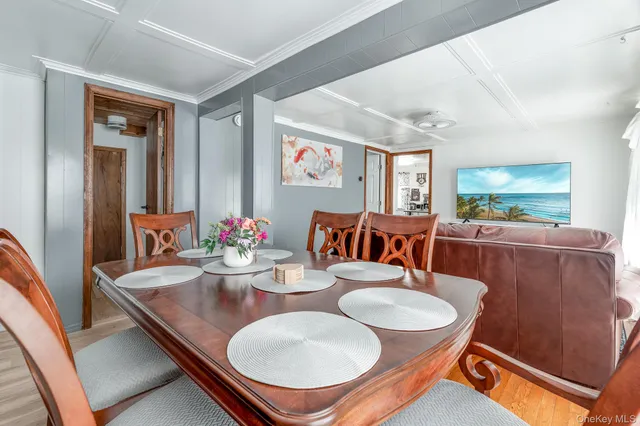 a dining room with furniture and wooden floor