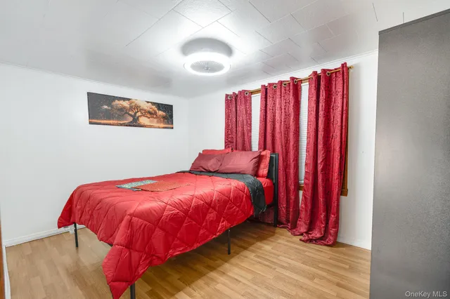 a bed sitting in a bedroom next to a window