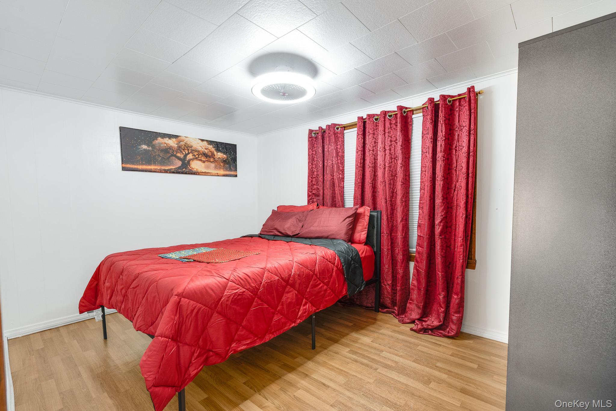 49 Delafield Street, Unit 1 Poughkeepsie, NY 12601 - Photo 15 of 24 a bed sitting in a bedroom next to a window