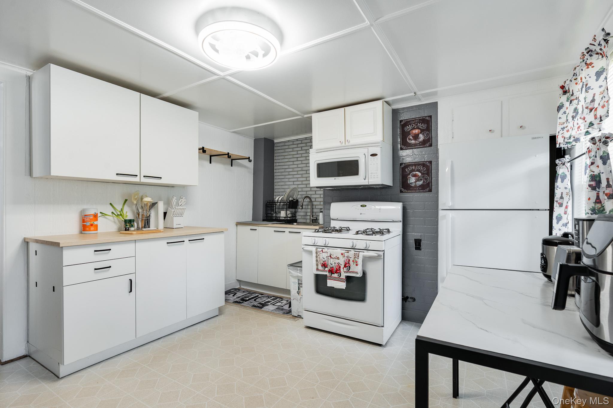 49 Delafield Street, Unit 1 Poughkeepsie, NY 12601 - Photo 6 of 24 a kitchen with a refrigerator a stove and a sink