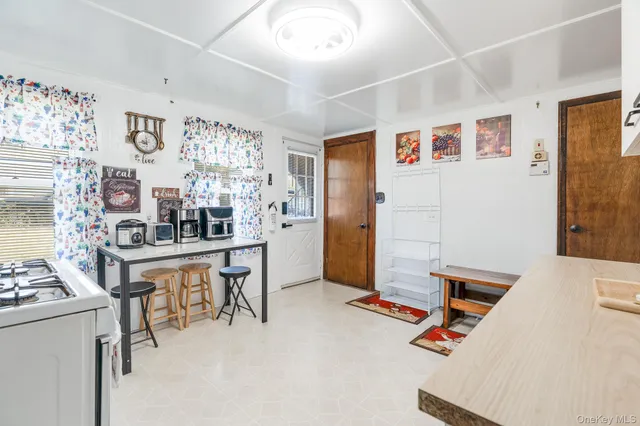a view of a livingroom with furniture and kitchen
