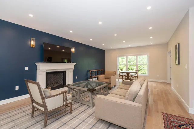 a living room with furniture a fireplace and a table