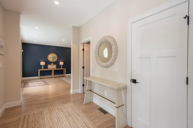 a living room with furniture and a mirror
