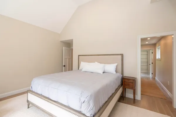 a large bed sitting in a bedroom and a table