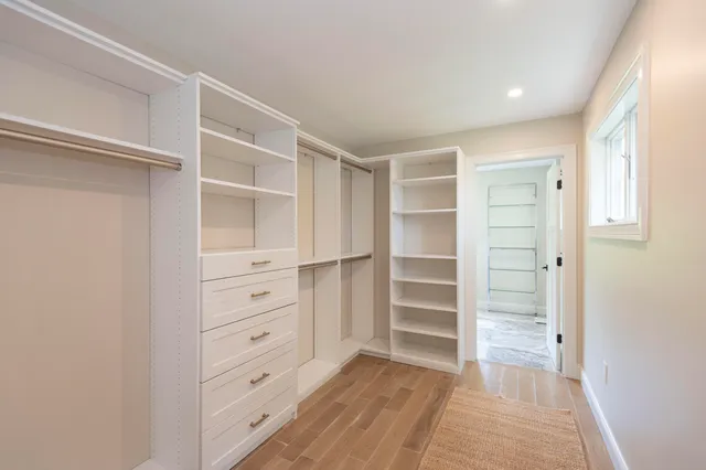 a view of walk in closet with empty racks
