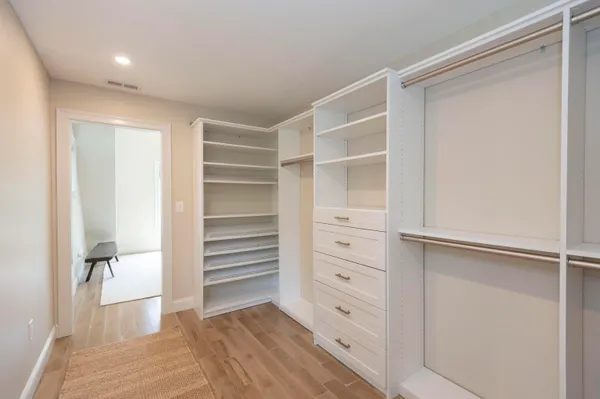 a room with a closet and mirror