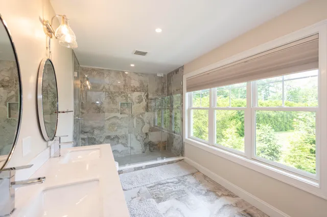 a bathroom with a sink a toilet and shower