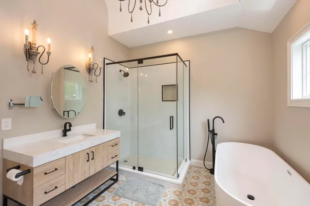 a bathroom with a double vanity sink mirror and shower