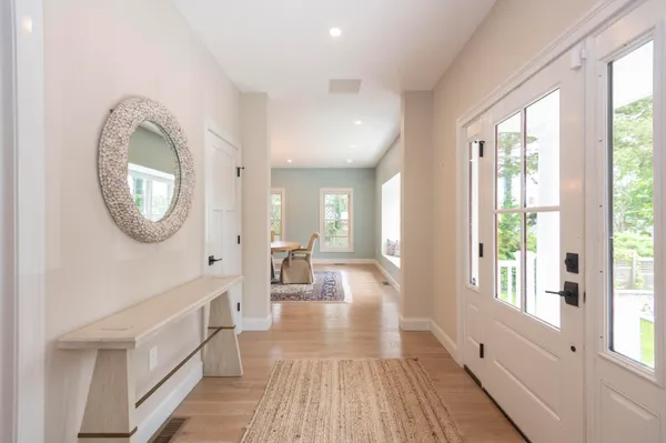 a view of a room with wooden floor and windows